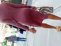 Wiggle booty tall slender darksome woman in pink