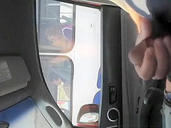 Boy strokes his dick in traffic next to woman in bus