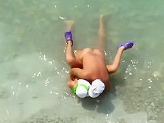 Kama Sutra on the beach Couples have sex in the sea