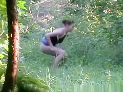 Woman in jeans petticoat void urine in the nature