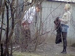 Sexy cuties urinate behind an abandoned abode