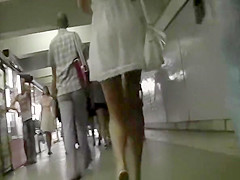 Golden-Haired woman in short white costume upskirt