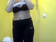 Short hair aged woman undressing and dressing