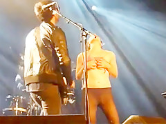 Audience hotty disrobes on stage during a concert