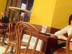 Upskirt of a lonely beauty in a coffee shop