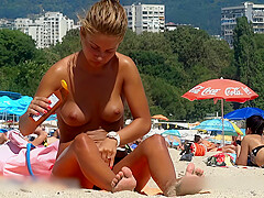 Wonderful looking topless angel at the beach