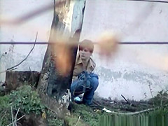 Hotty pees next to large wall