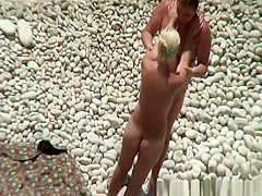 Breasty golden-haired nudist swimming in the water