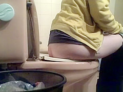 Angel lifts WC seat and seats to take a pee