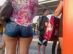 Woman with fine arse in taut shorts