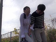 Older Japanese wife remote control sextoy outside stroll