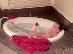 Older woman facetimes when fingering her clitoris in the tub