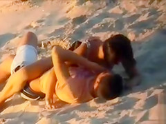 Impressive doll enjoys a dude's 10-Pounder in the sand