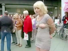 Compliant woman fastened and undressed in public
