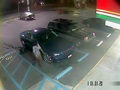 Despairing dark woman soaks the parking lot next to the car