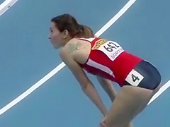 Built woman runs around the track in a flimsy outfit