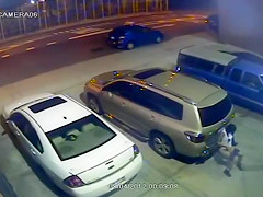 Security camera catches a beauty peeing behind a car