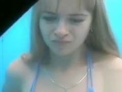 Cute legal age teenager putting on a blue bikini