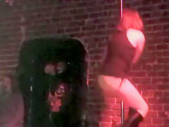 Drunken dancer in boots works the stripper pole