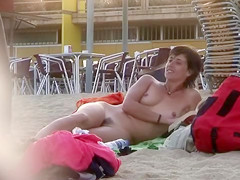 Handsome Italian woman sunbathes absolutely exposed