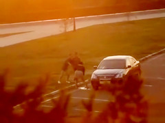 Unaware girl makes water on the parking lot
