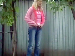 Golden-Haired beauty in taut jeans panties peeing outdoors