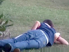 Boy finger blond behind large bush