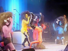 Painted meatballs bounce around on the stage at a rock concert