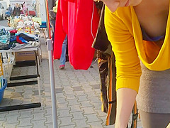 Street market seller has her large cleavage caught on the camera