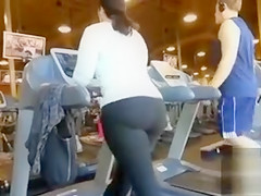 Chunky gazoo woman walks on the treadmill