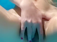 Bare girl sucks my pecker in the pool