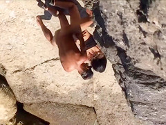 Filly's bawdy cleft receives permeated on the rocky beach