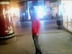 Drunken girl pissing on a public sidewalk