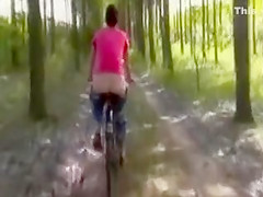 Kinky Gal with Undressed Butt Rides the Bicycle Outdoors