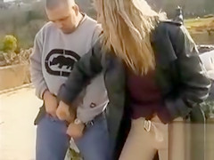 Blond lady gives a great tugjob in public