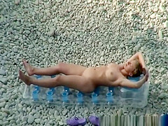 Woman arrives to the beach and strips