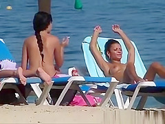 Gorgeous topless beauties sunbathing on the beach