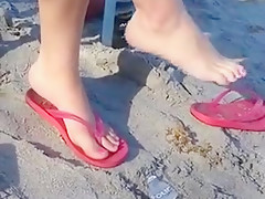 Crossed Legs Dangling on the Beach