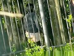 Woman pissing in public park