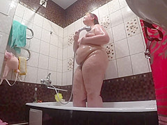 Lesbo has installed a hidden camera in the bath at his girlfriend. Peeping behind a big beautiful woman with a large gazoo in the shower. Voyeur.