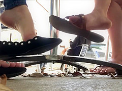 Candid flats dangling underneath table