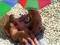 Trio sex enjoyment on public beach caught on voyeur webcam