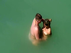 Beach pair sex in the sea